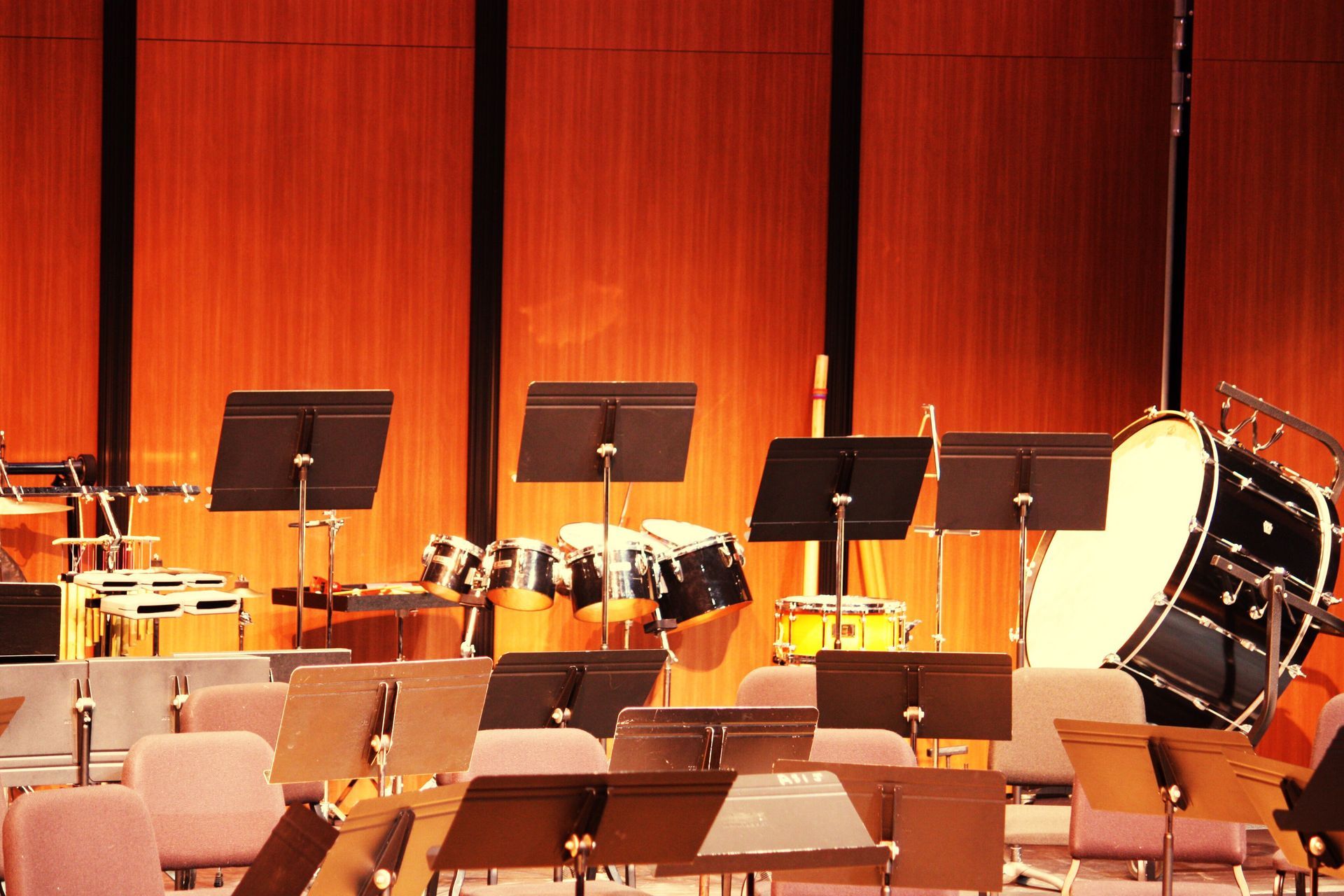 A large drum sits on a stage in an empty auditorium