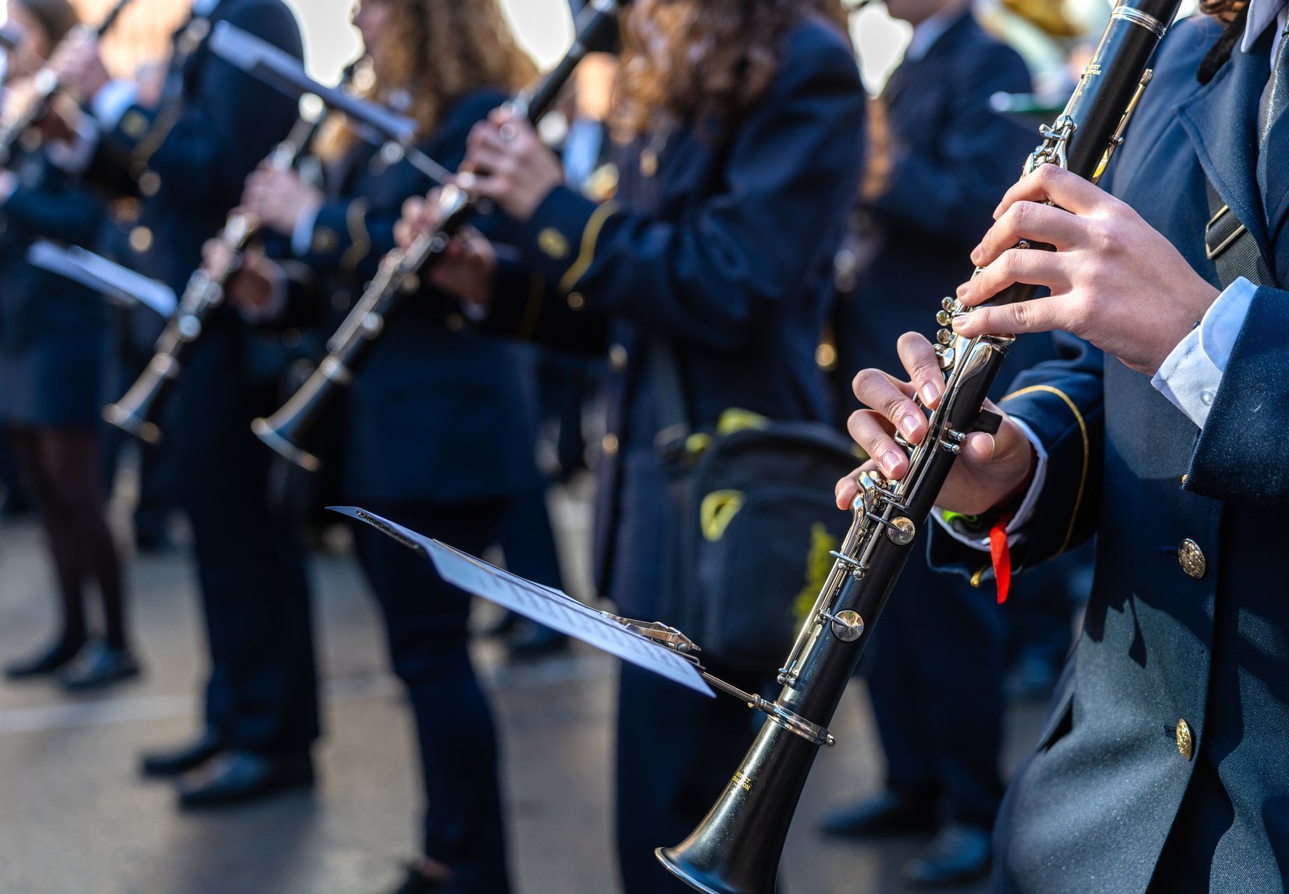 A group of people are playing clarinets in a band.