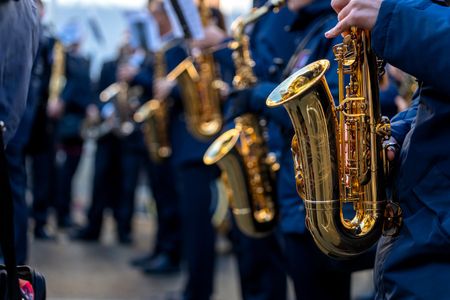 A group of people are playing saxophones in a band.
