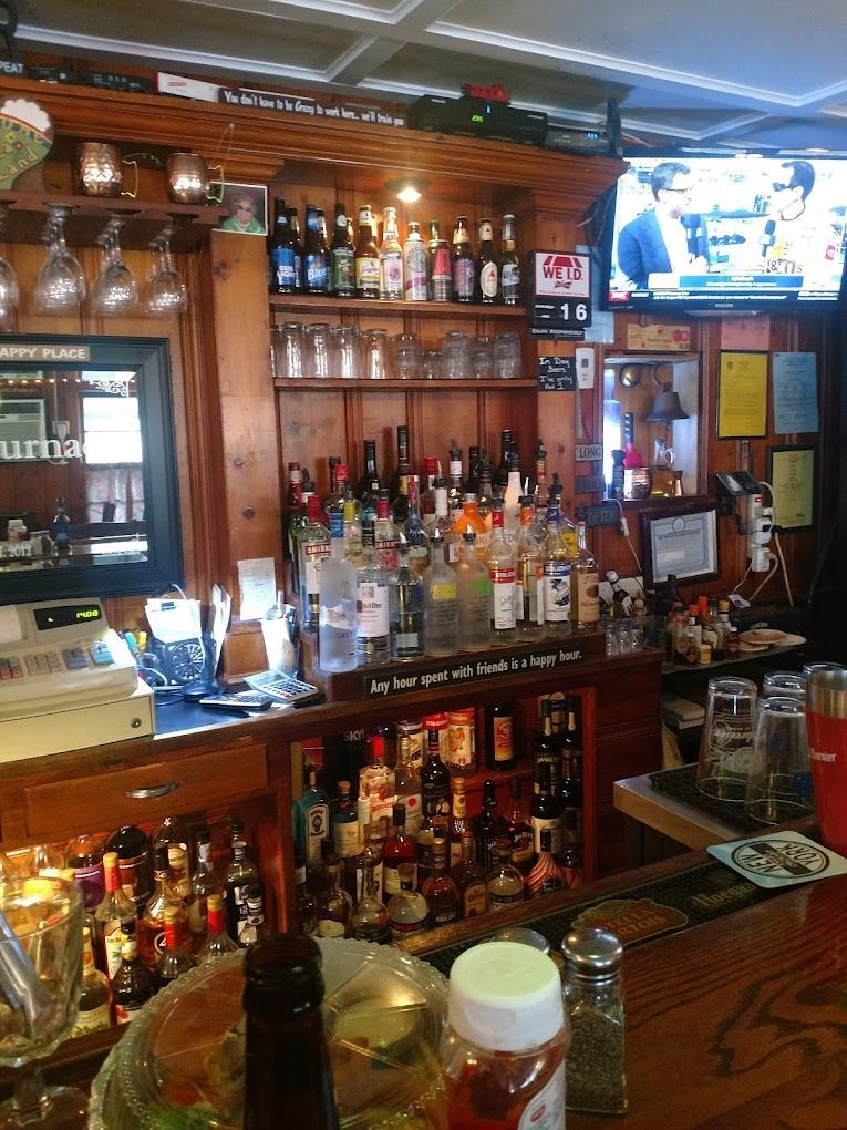A bar filled with lots of bottles and glasses
