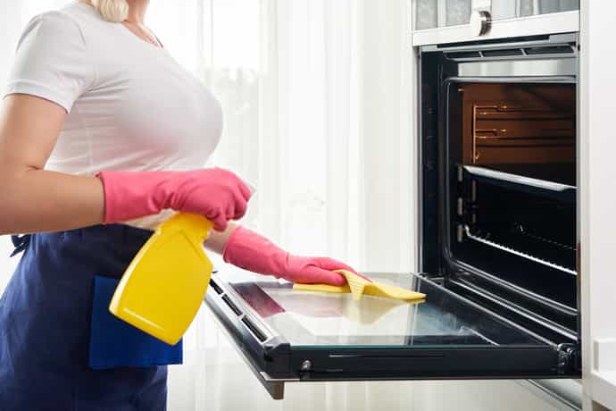A cleaner using special cleaning agent during oven cleaning process at Berkshire cleaning 