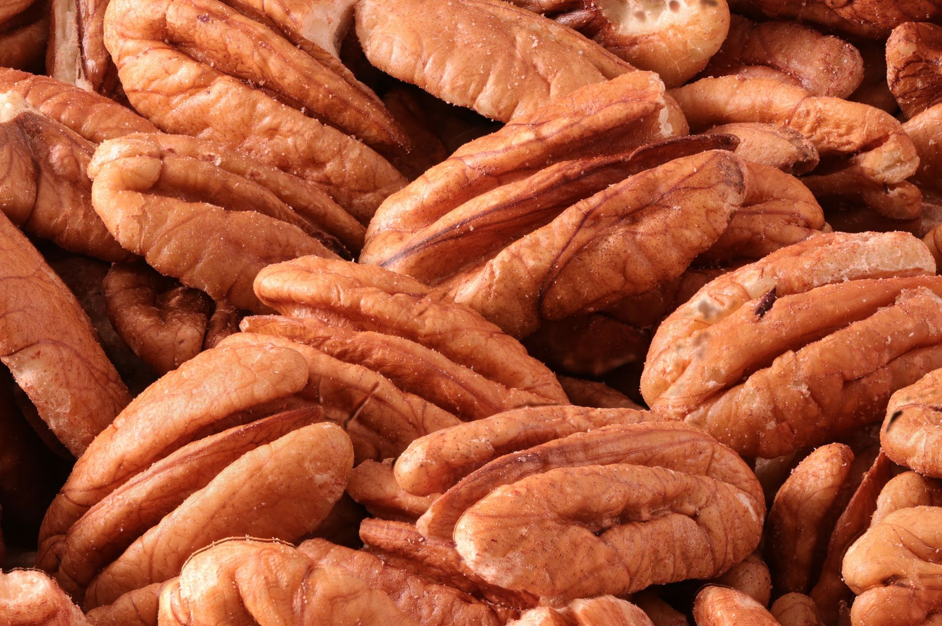 Pile of brown pecan halves.