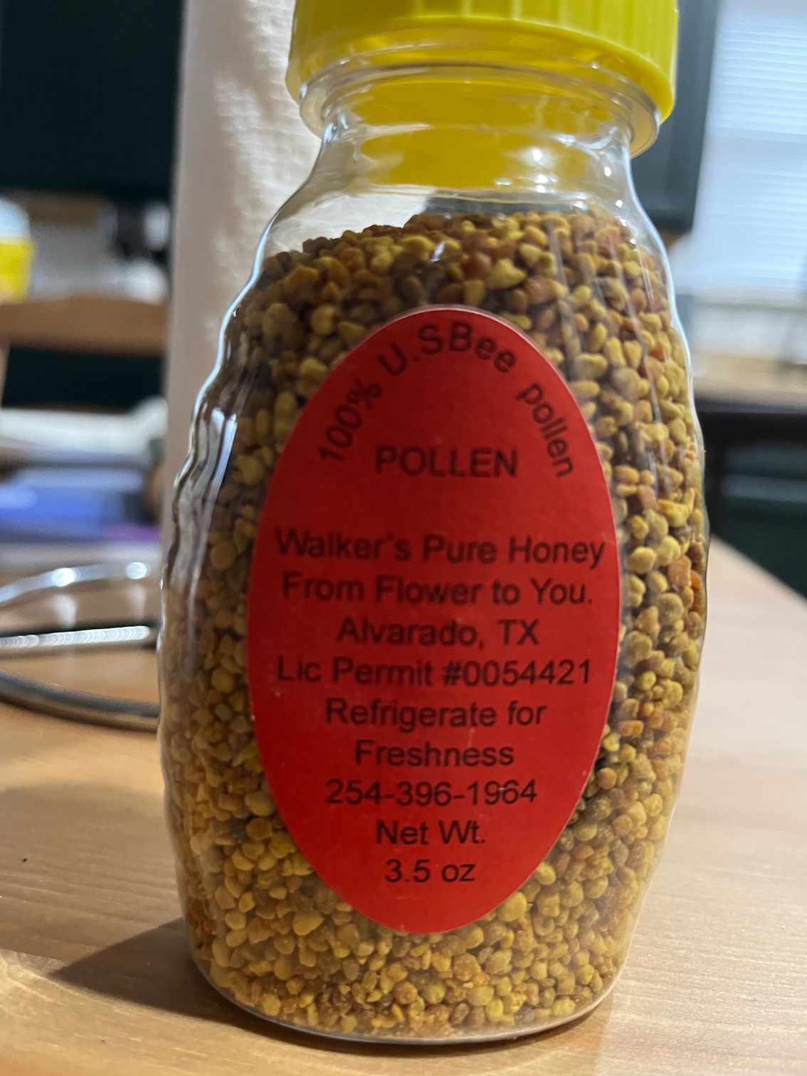 Jar of bee pollen with red label: