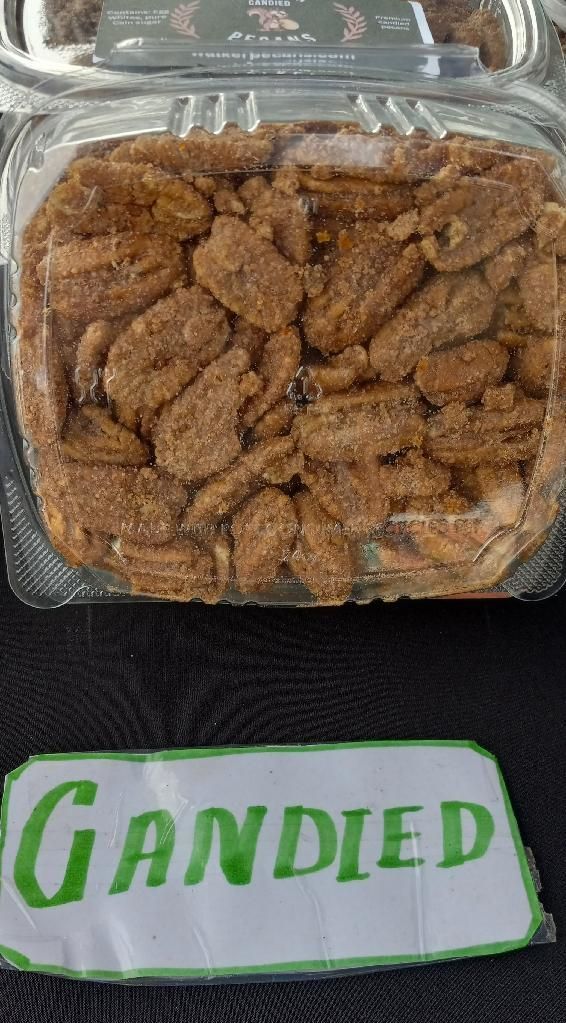 Candied pecans in a clear container, with a