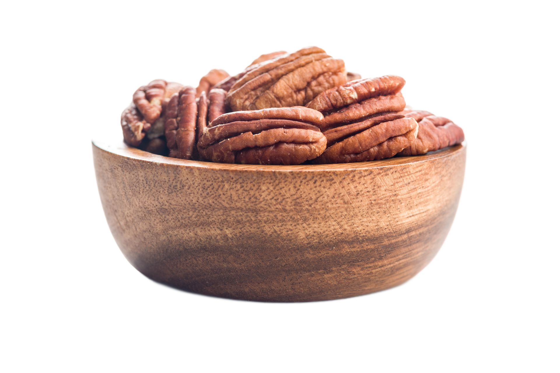 Bowl of almonds spilling onto a white surface.