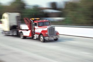 Cab of semi truck being towed down highway - Towing in Wenatchee, WA