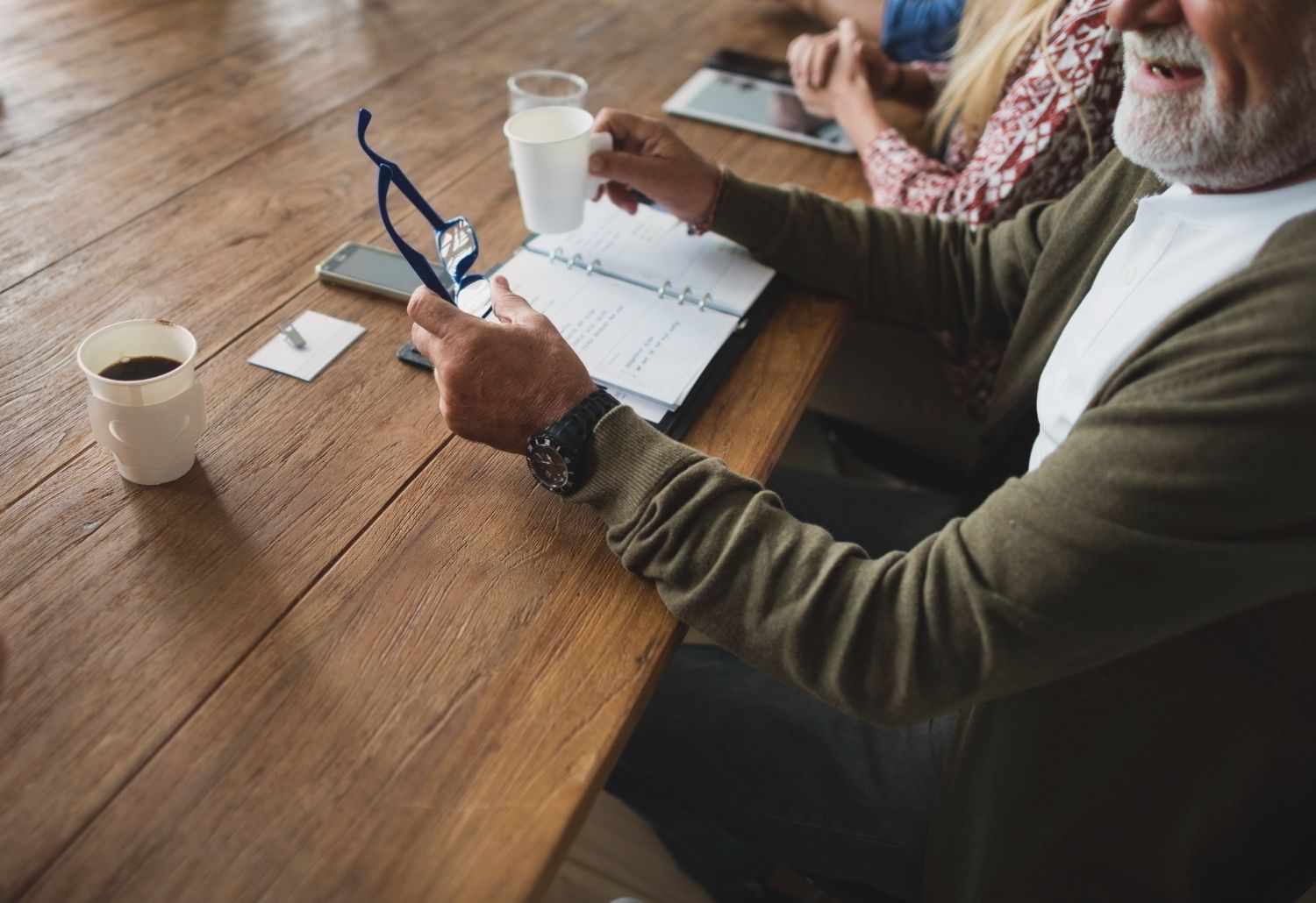 A man and woman are walking down a road with a child.