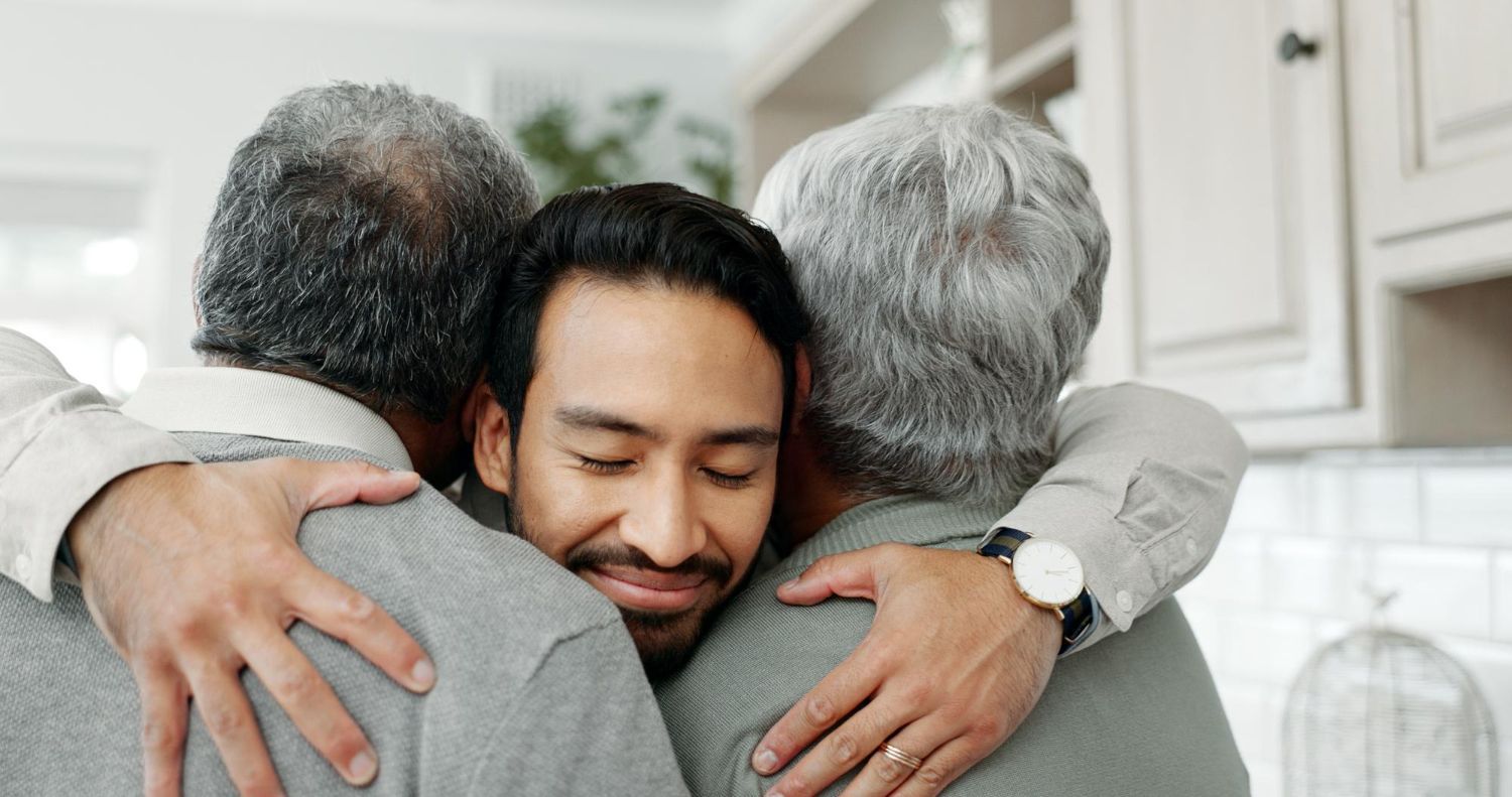 A man and woman are walking down a road with a child.