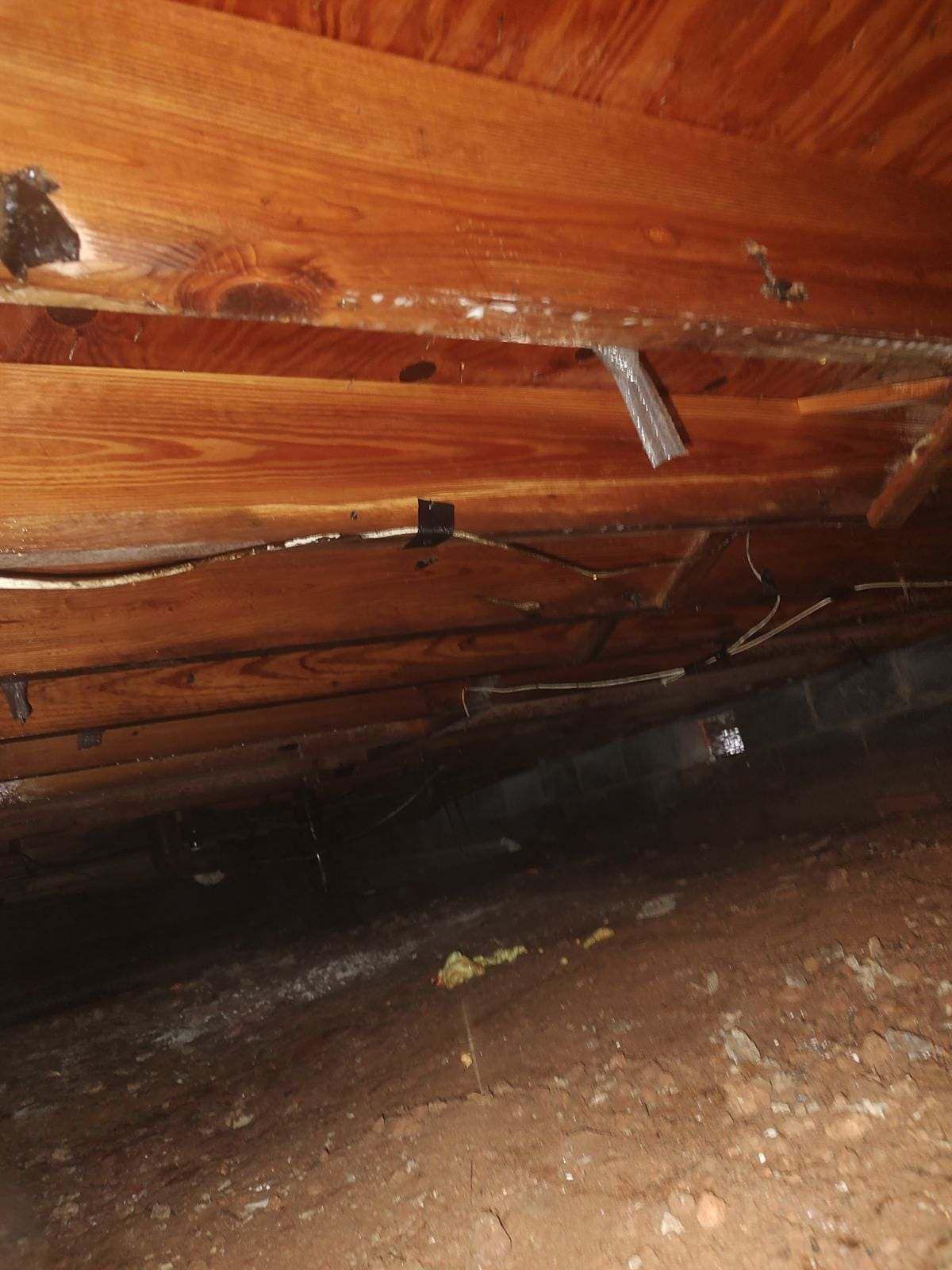 A wooden floor with a lot of wires coming out of it.