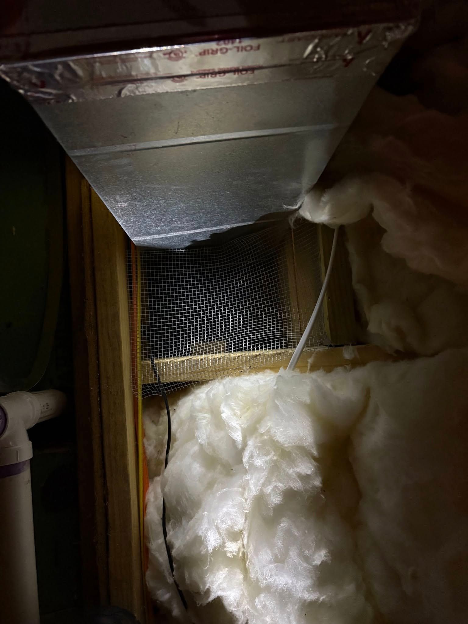 A person is looking through a hole in the ceiling of a house.