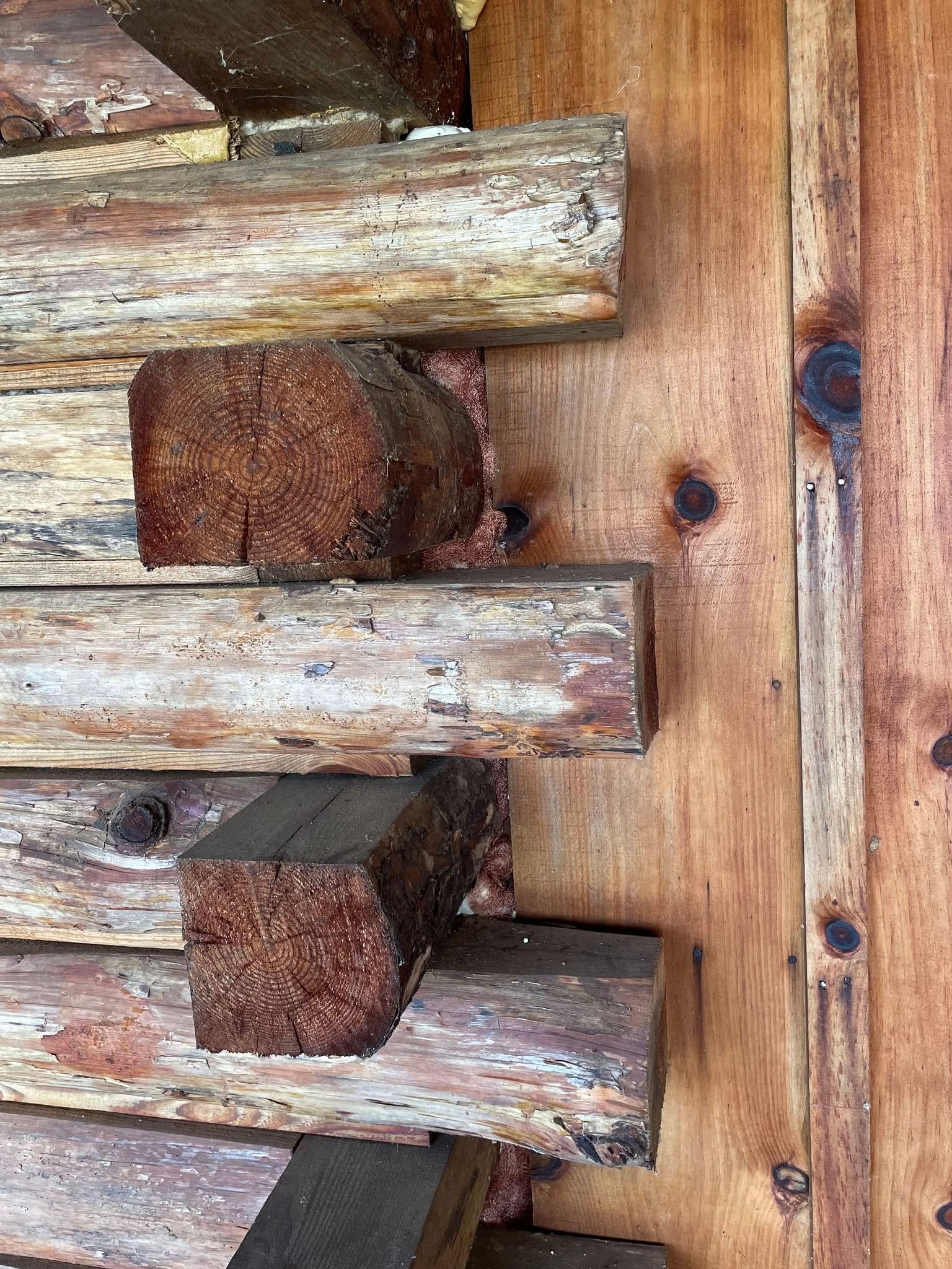 A stack of logs sitting on top of each other on a wooden surface.