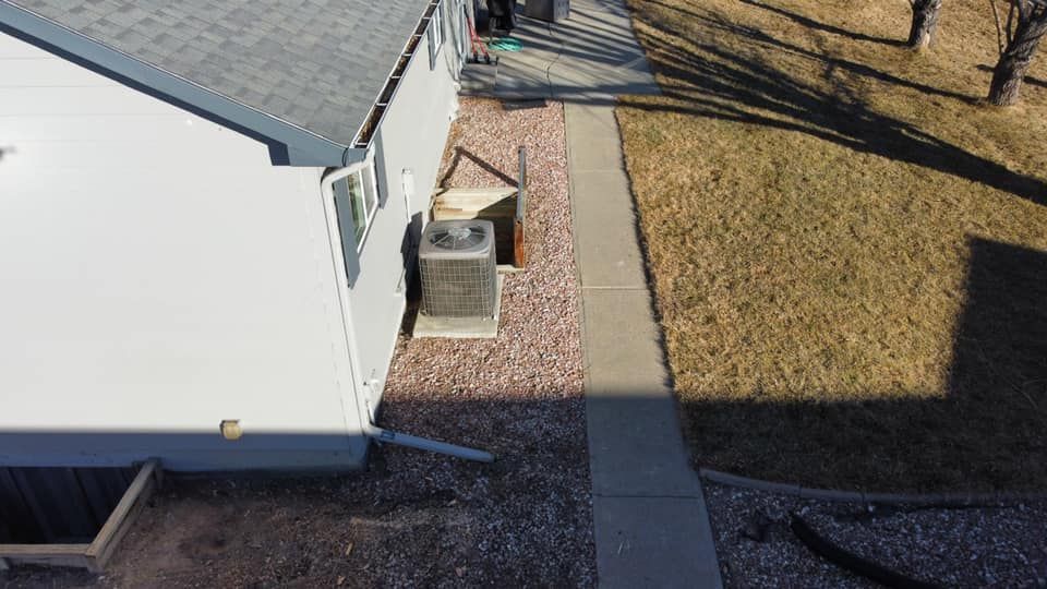 An aerial view of a house with a walkway leading to it.