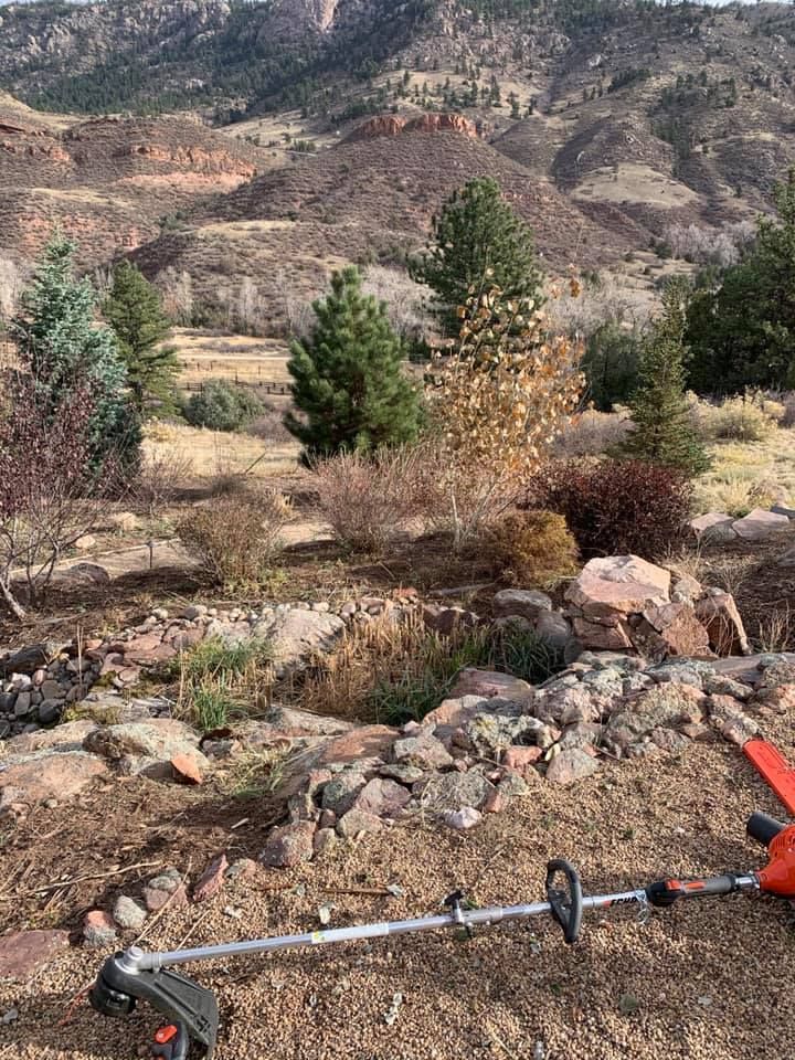 A lawn mower is sitting on top of a rocky hillside.