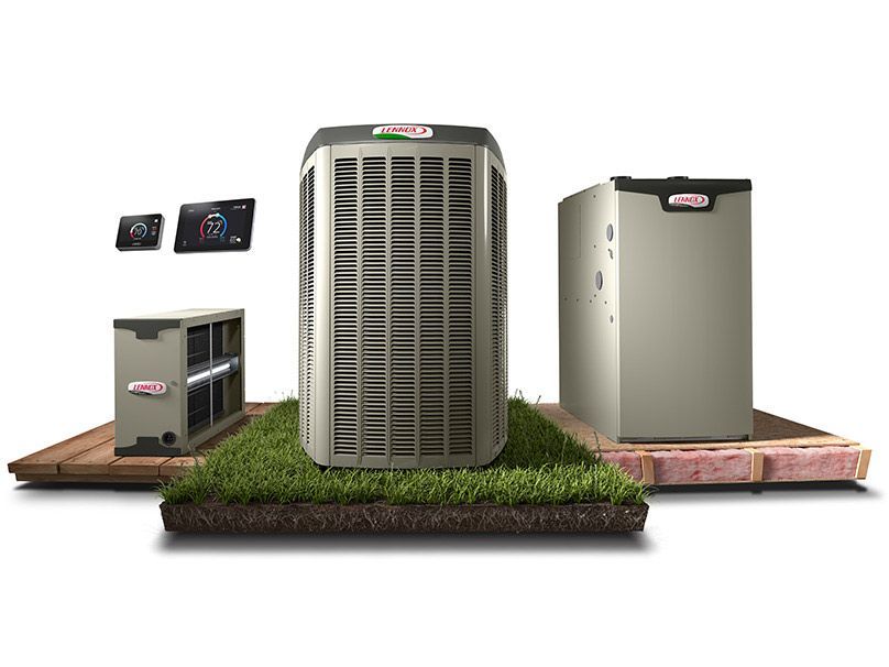 A group of air conditioners sitting on top of a piece of grass.