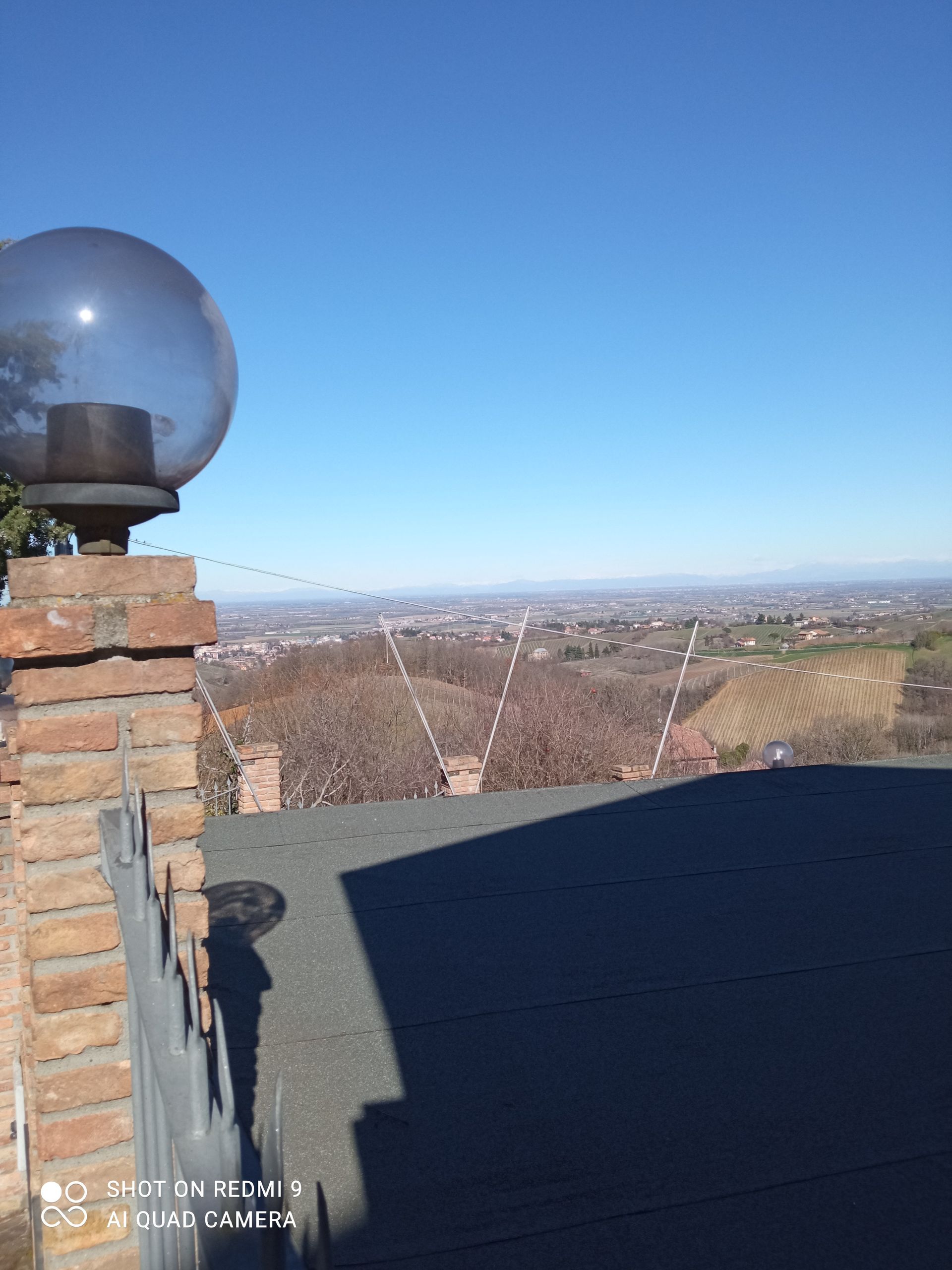 Una luce in cima a un palo di mattoni con vista sulla città.