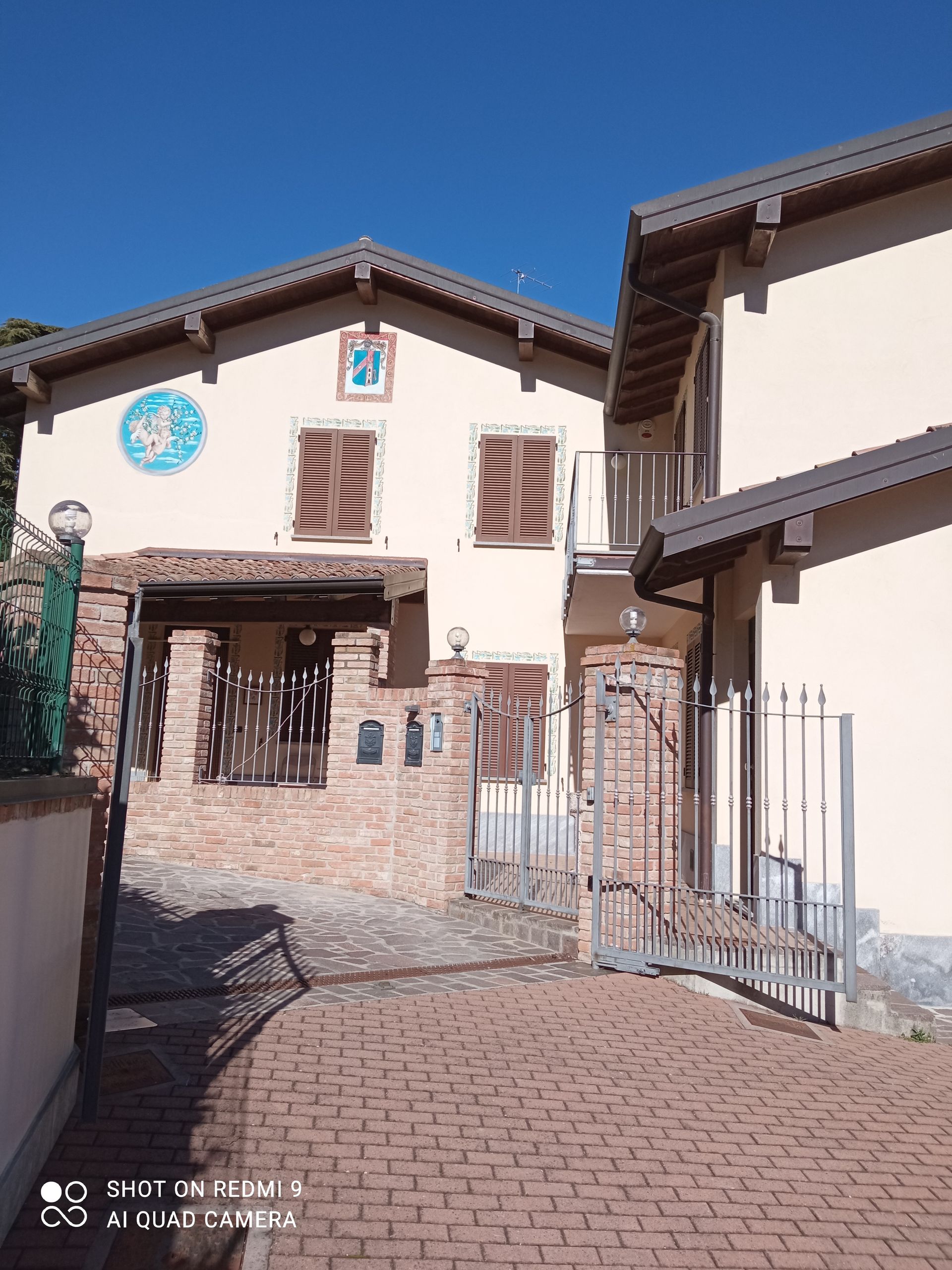 Una casa bianca con un sentiero in mattoni che vi conduce.