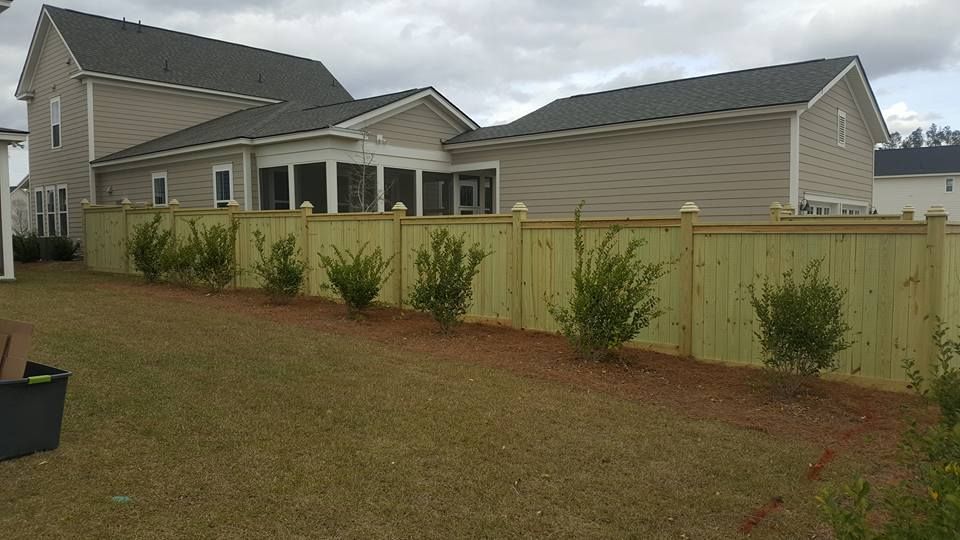 A house with a wooden fence in front of it