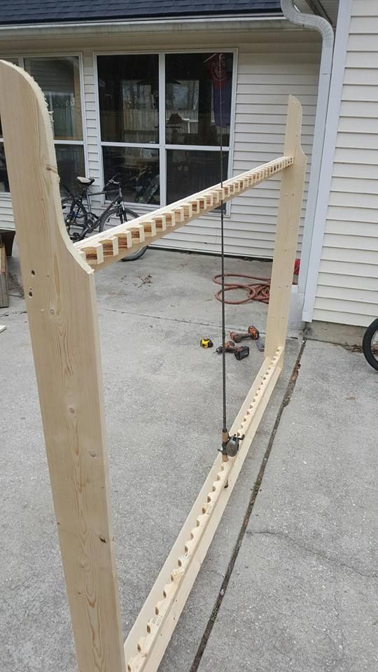 A wooden frame is being built on a patio in front of a house.