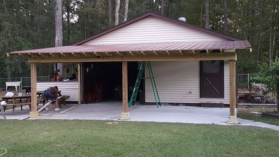 A house with a porch and a ladder in front of it