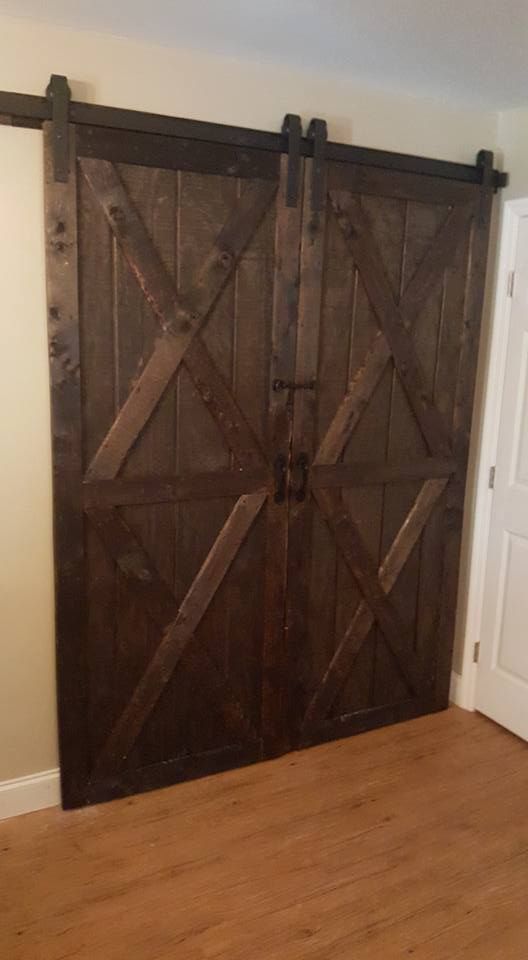 A pair of wooden sliding barn doors in a room.