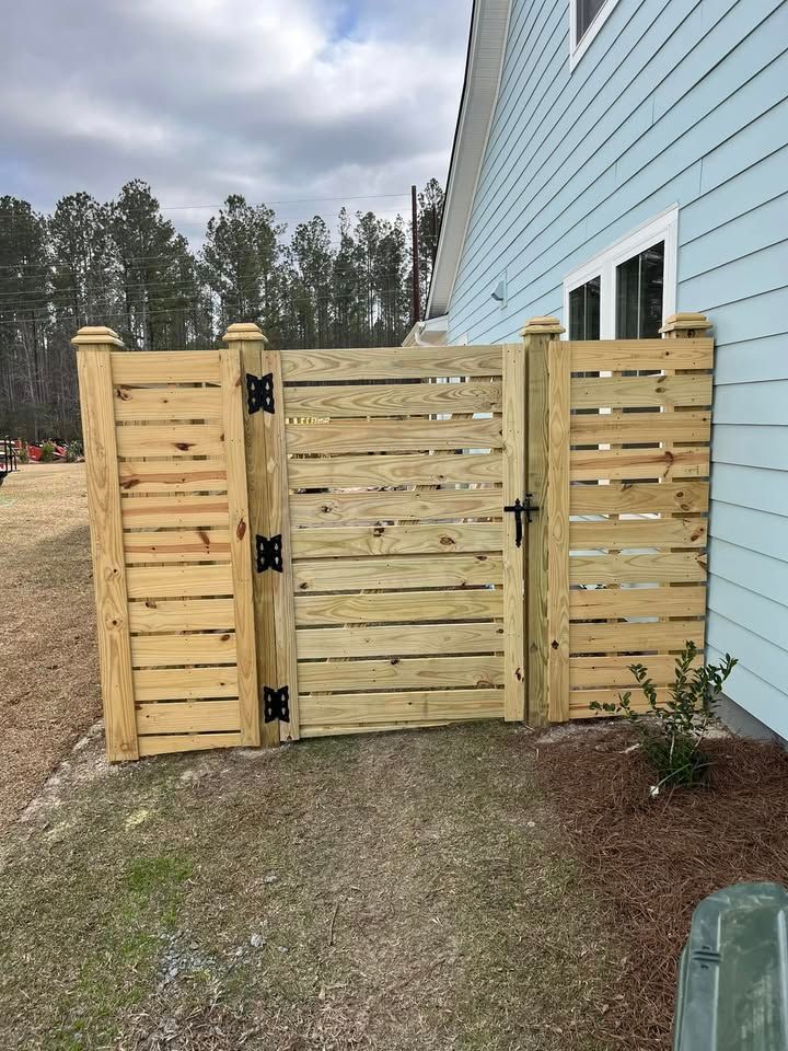 A wooden gate is sitting in front of a house.