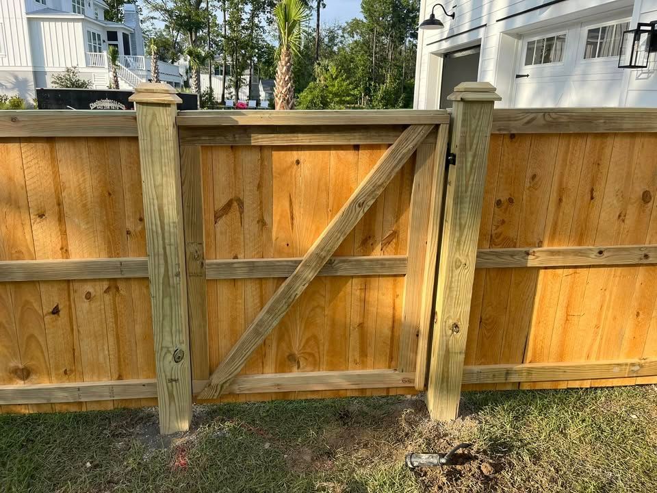 A wooden fence with a gate attached to it.
