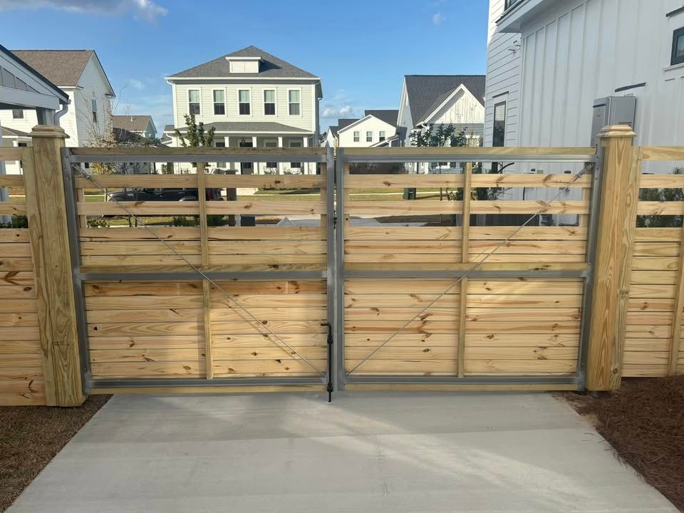 A wooden gate with a house in the background