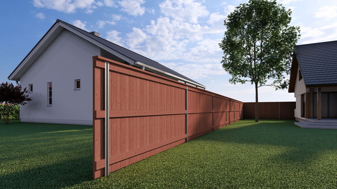 A wooden fence is surrounding a house in a backyard.