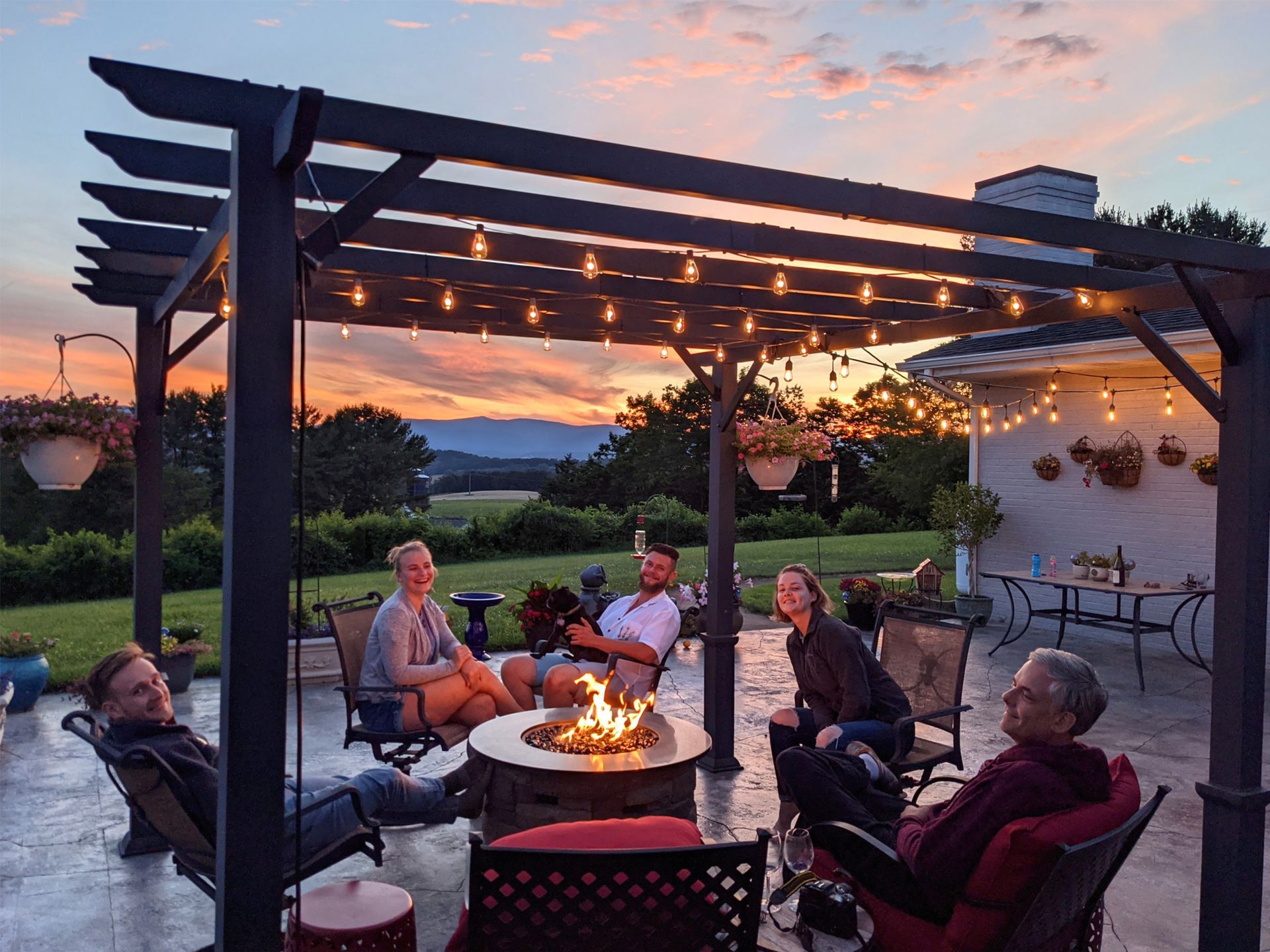 There are two chairs and a table on the patio.