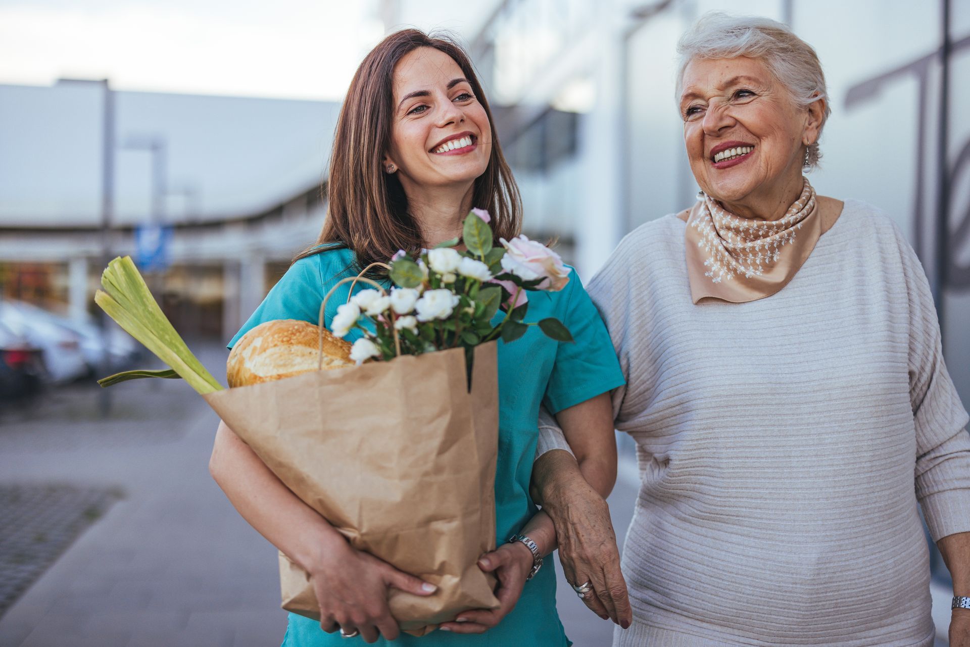 Woman carrying groceries and flowers
