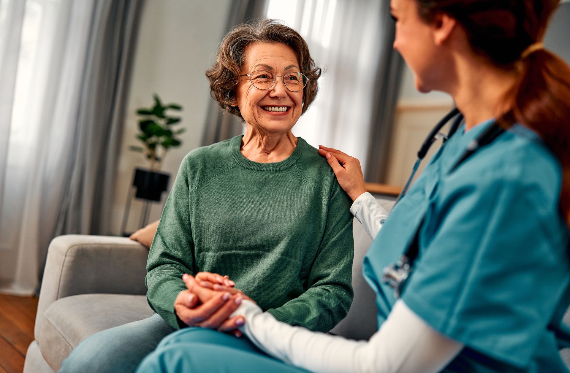 Elderly woman smiling with a healthcare worker