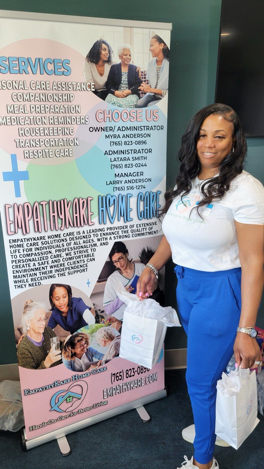 Smiling woman in wheelchair with caregiver in a kitchen