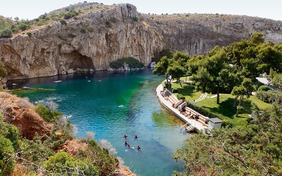 Lake Vouliagmeni surrounded by cliffs and greenery
