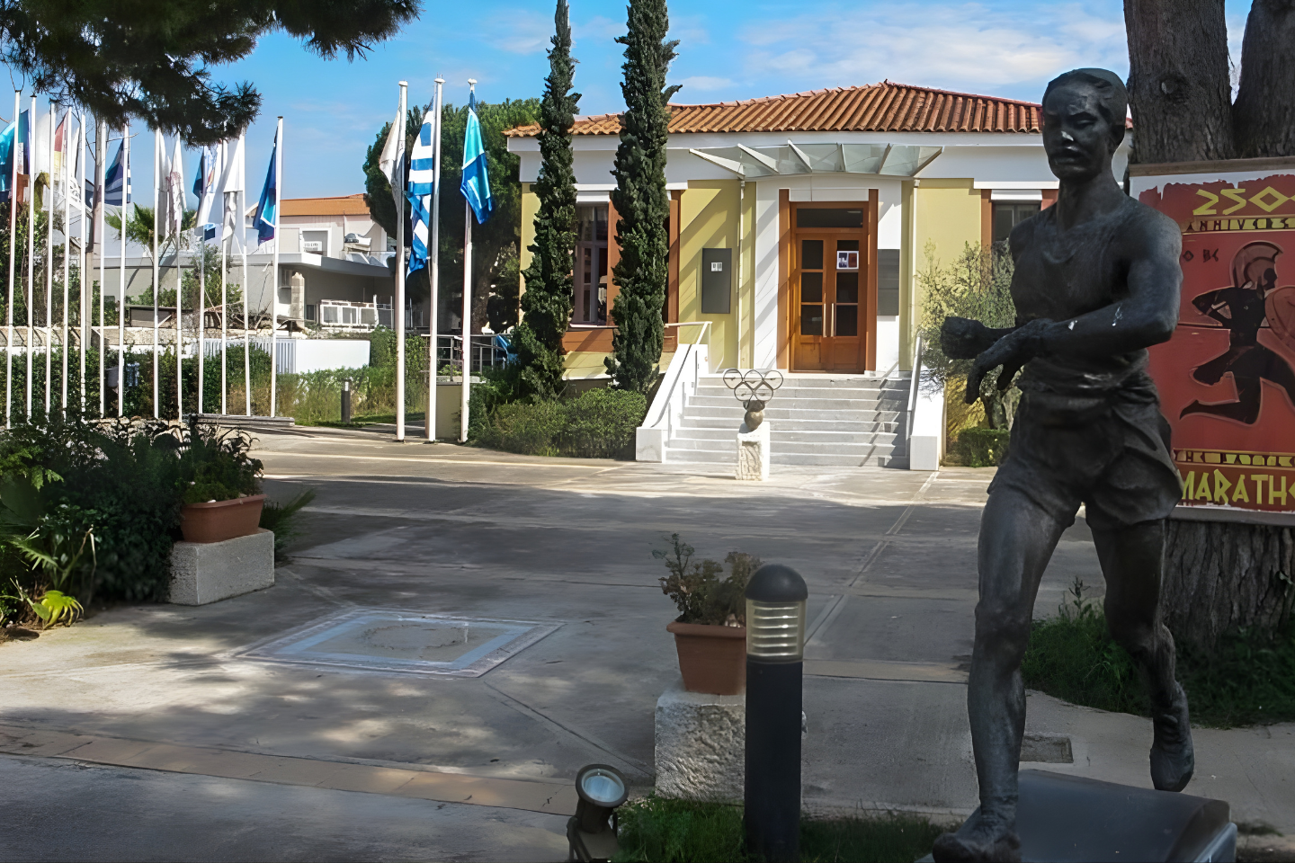 Entrance of the Marathon Run Museum with the bronze statue of a marathon runner.