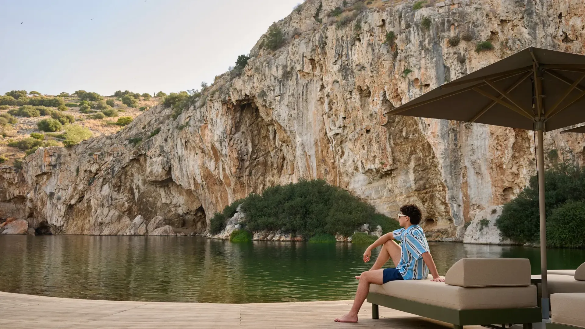 Woman relaxing by Lake Vouliagmeni natural spa