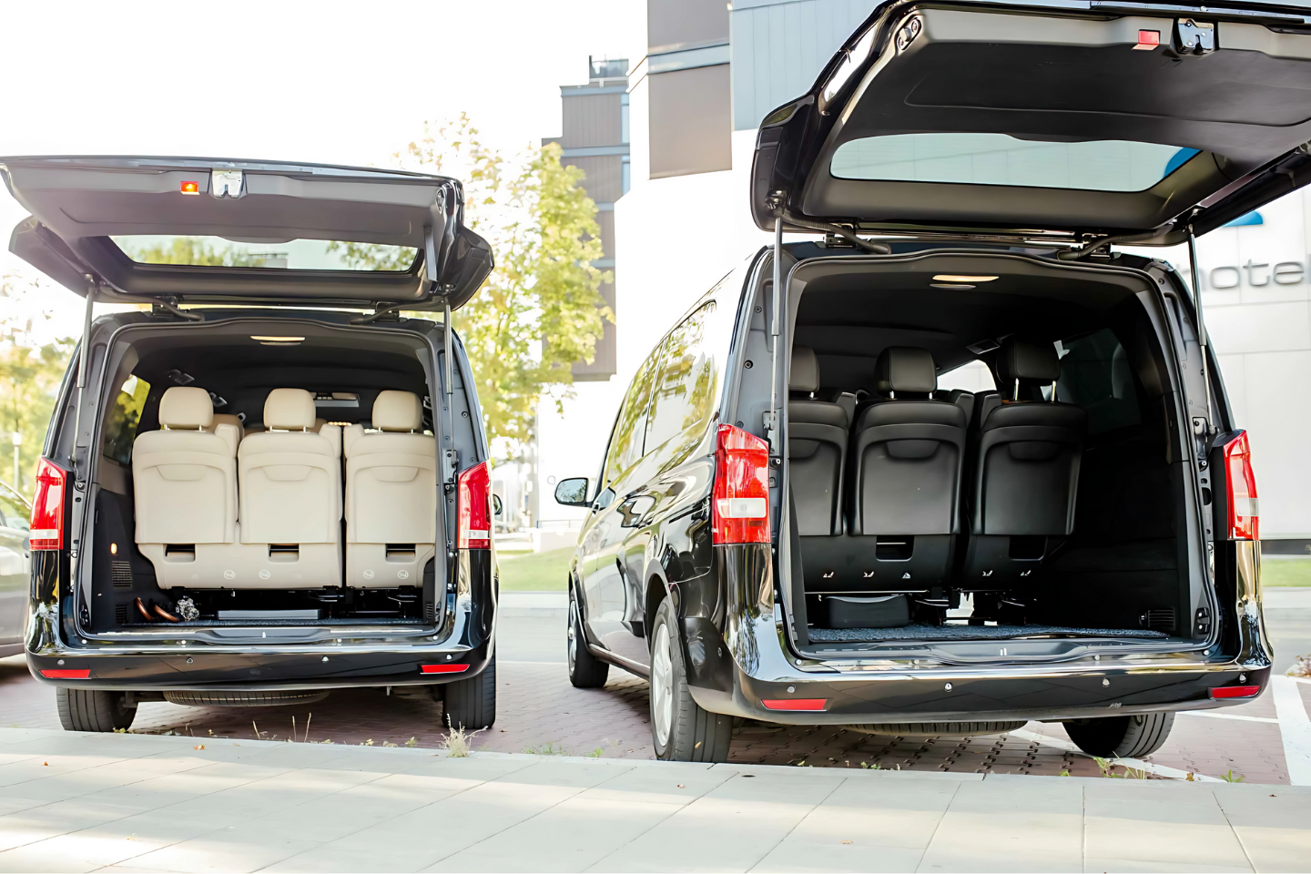 Rear cargo and passenger seating space of an Athenaos luxury Mercedes van with open tailgate.