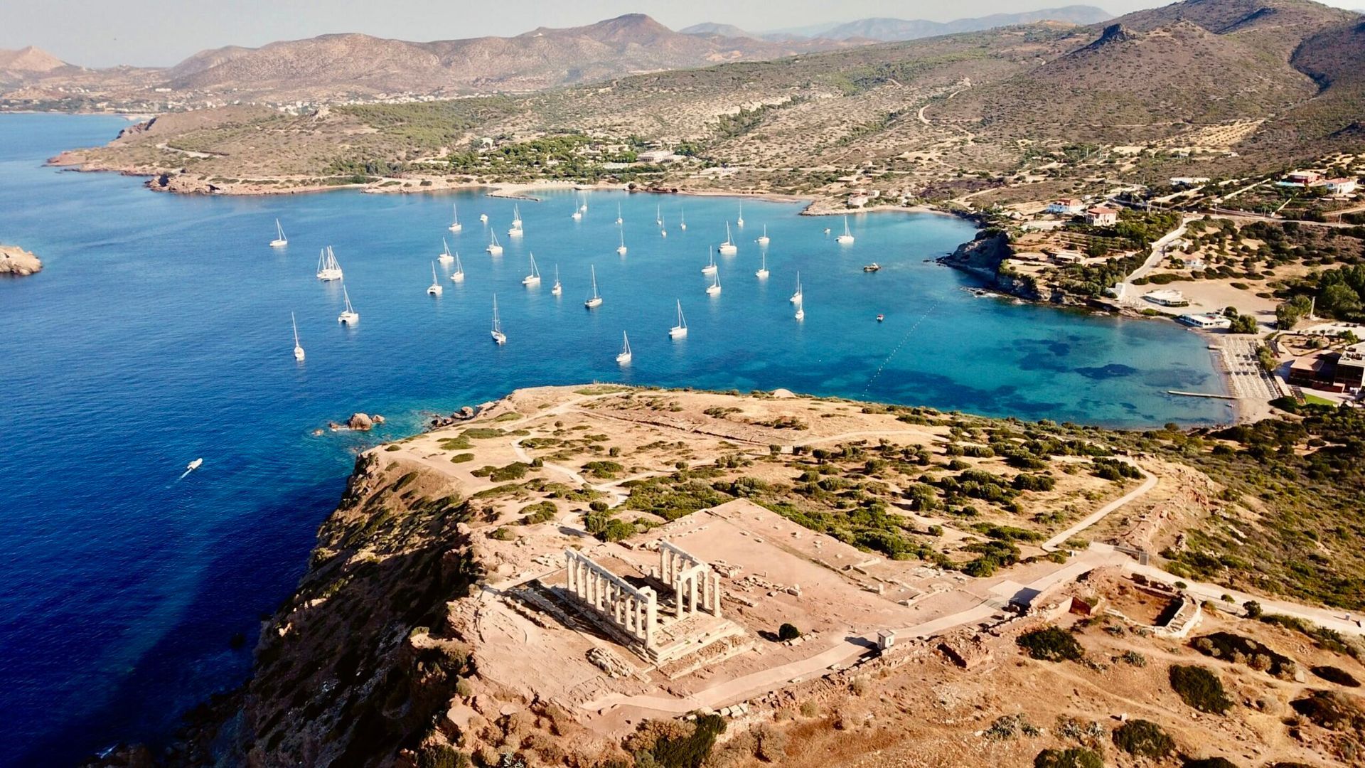View of the Aegean Sea and Cape Sounion with boats and coastline