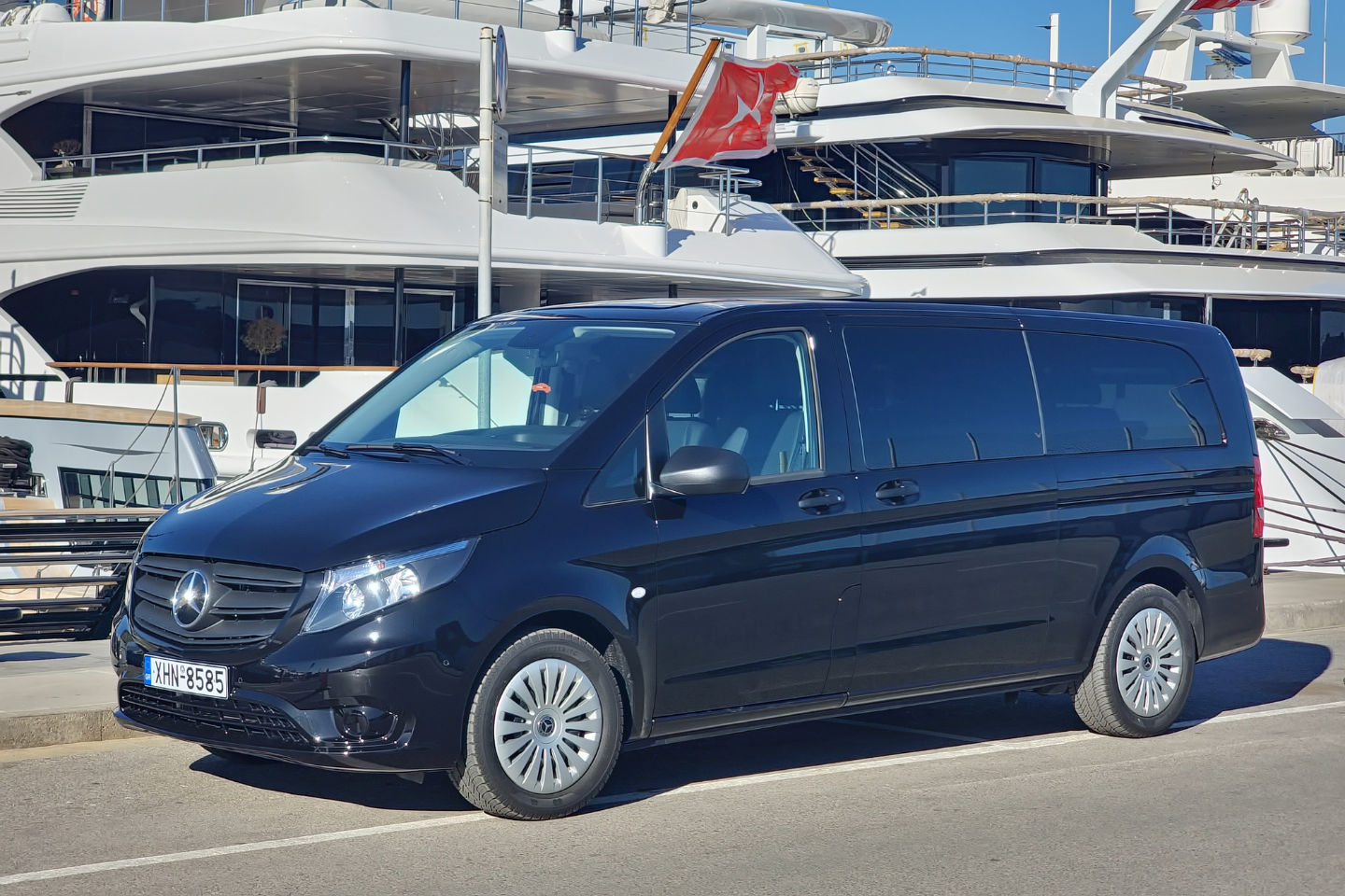 Athenaos black Mercedes van parked at a marina for private cruise and port transfers.
