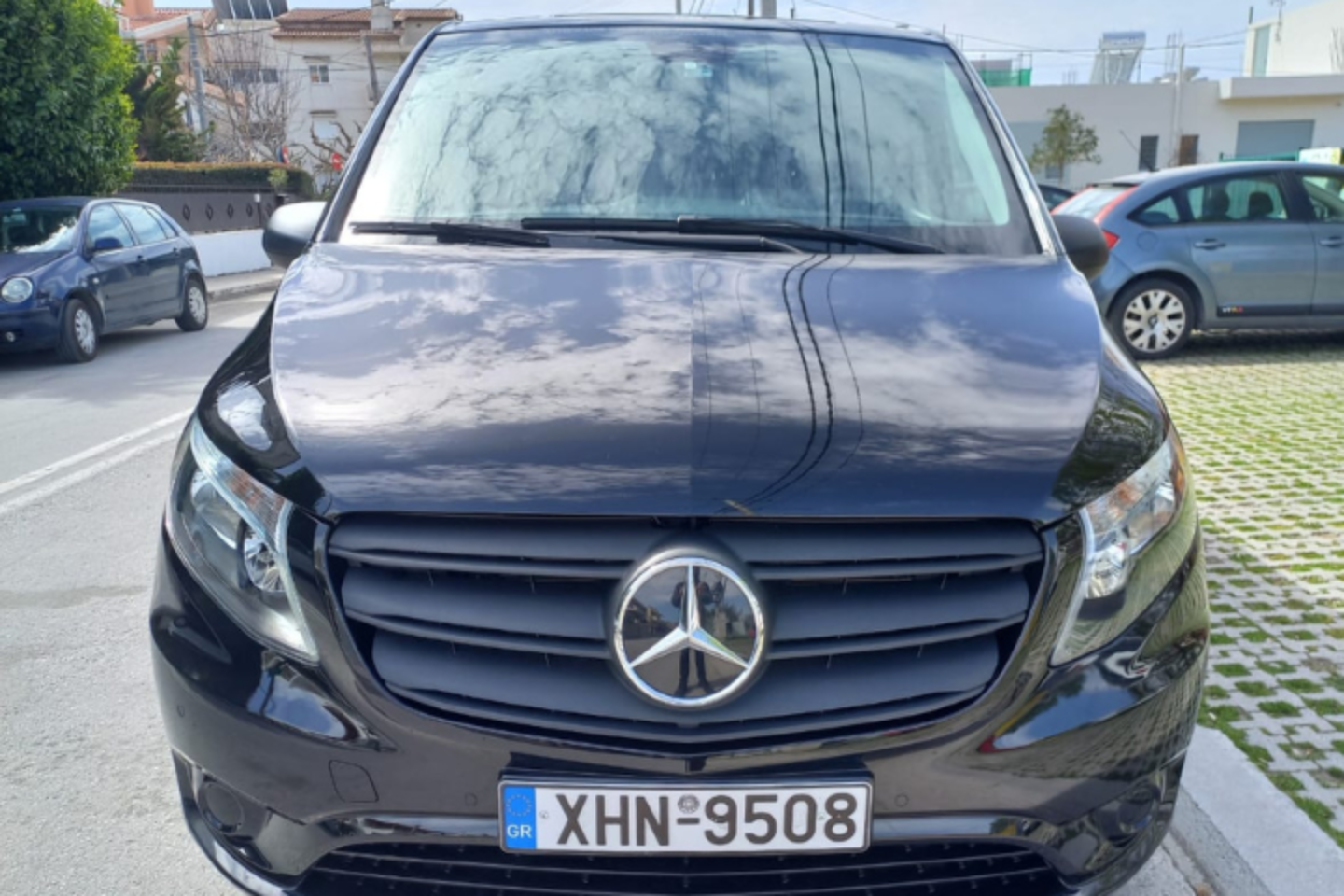 Front view of an Athenaos premium black Mercedes van used for private transfers in Athens.