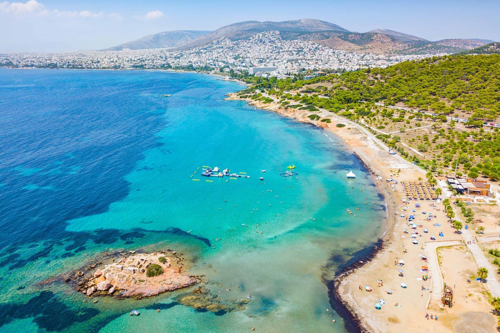 Aerial view of Vouliagmeni coastline with turquoise waters and sandy beach