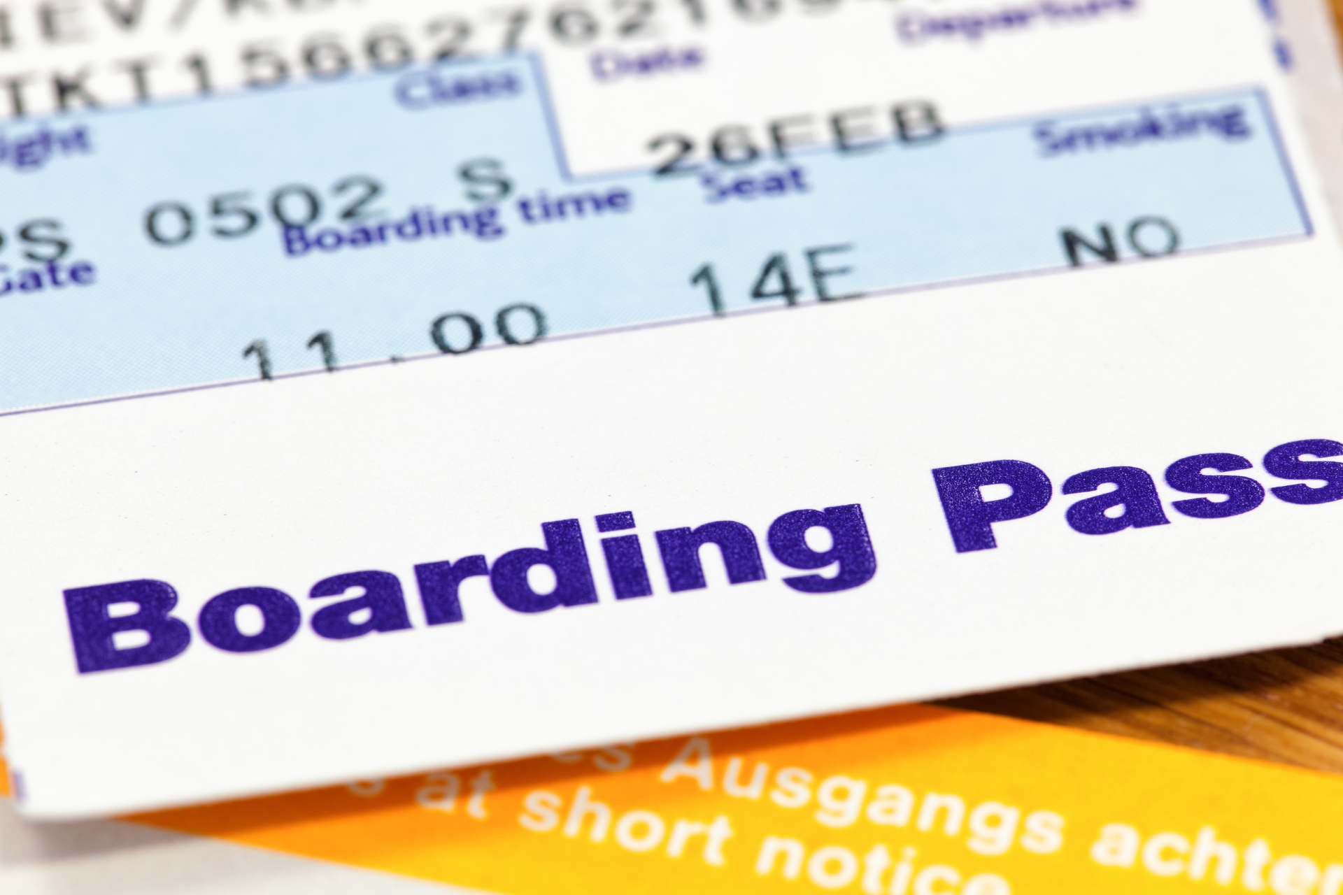 Close-up of airplane boarding pass symbolizing ticket booking and travel with Athenaos.