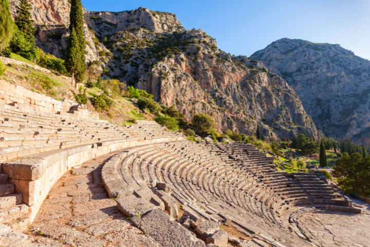 Ancient theater of Delphi with panoramic mountain backdrop
