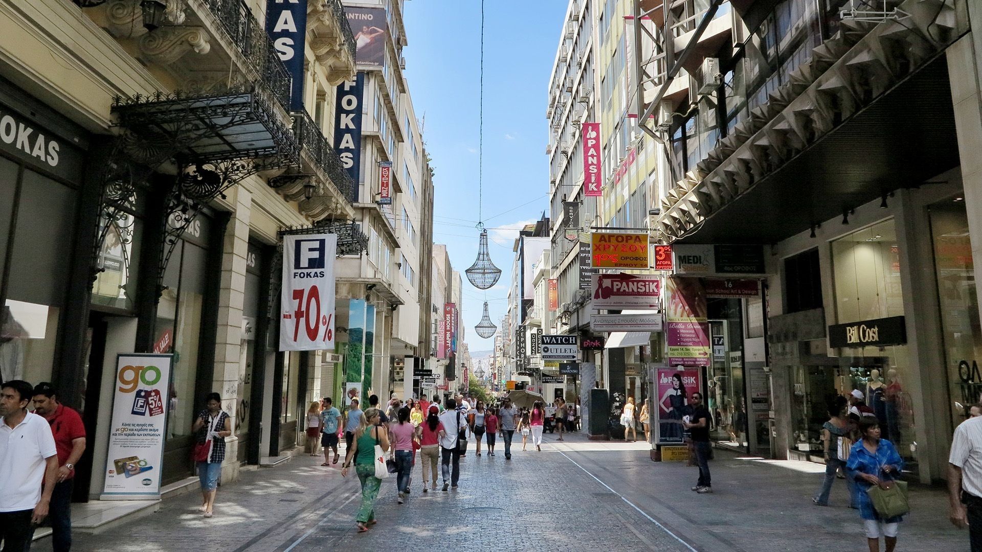 Busy Ermou Street with shops and pedestrians in Athens city center