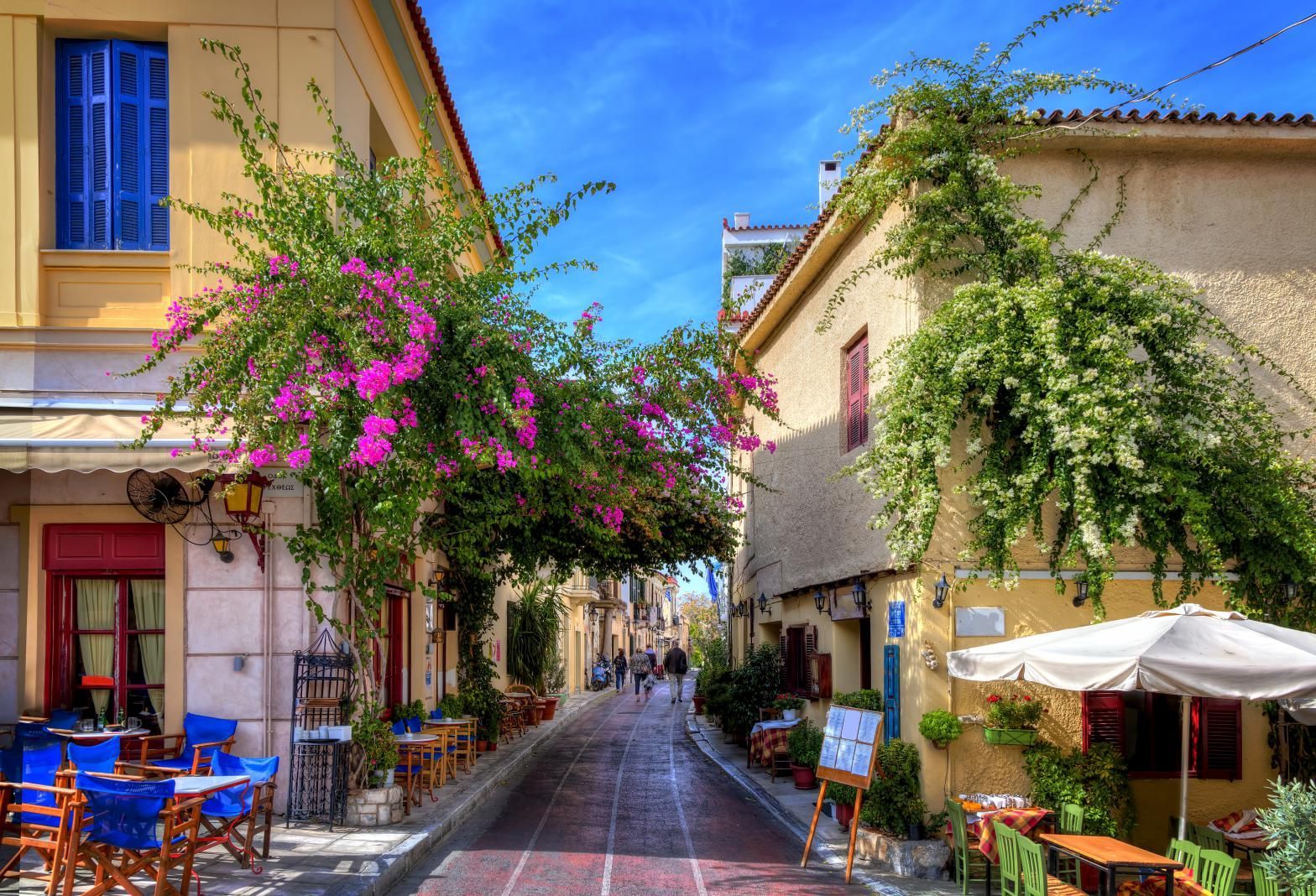 Charming pedestrian street with tavernas and flowers in Plaka, the old historical neighborhood of Athens