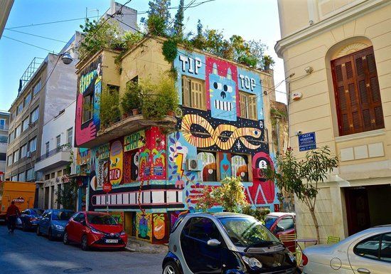 Colorful street art mural on a building in the vibrant Psyrri neighborhood of Athens