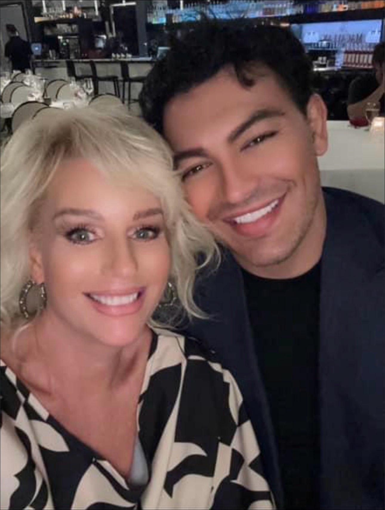 A man and a woman are posing for a picture and smiling