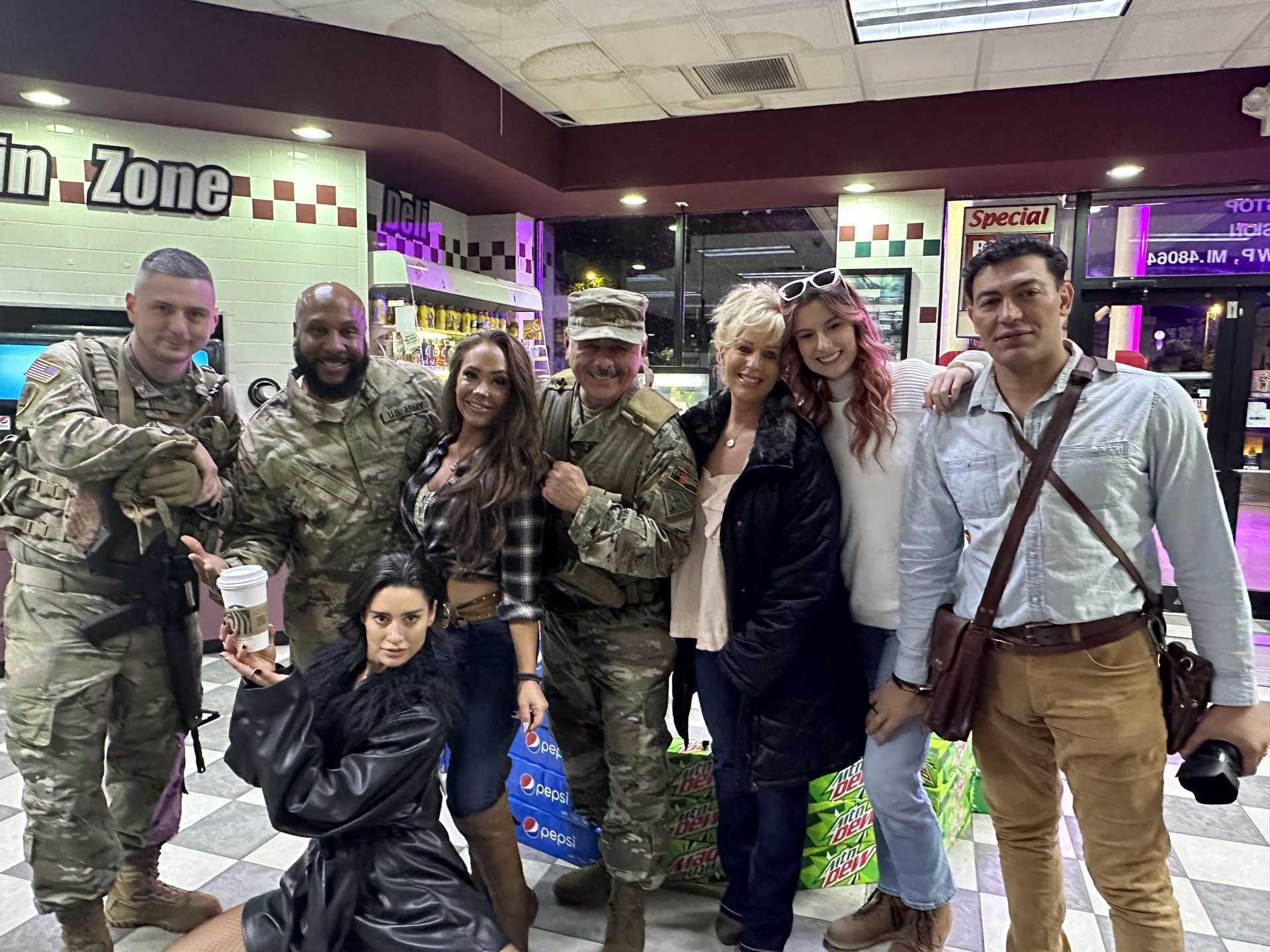 A group of people are posing for a picture in a room.