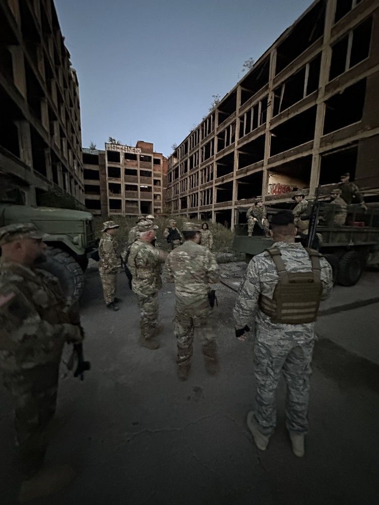 A group of soldiers are standing in front of a building.