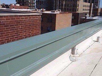 Finished metal coping with Wickright passive ventilation installed underneath on parapet wall in Uptown neighborhood of Chicago, IL. Building is now dry.