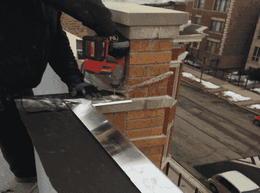 WickRight capstone vented drip edge being installed on parapet wall in Grand Boulevard neighborhood, Chicago, IL. Building is now dry.